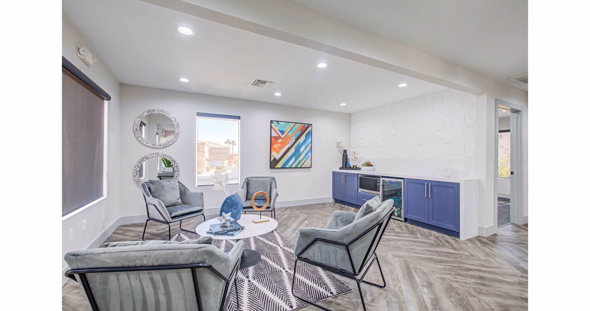 Modern clubhouse with stylish seating and large TV at Citron Apartments, a Greystar luxury community