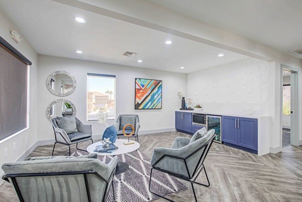 Modern clubhouse with stylish seating and large TV at Citron Apartments, a Greystar luxury community