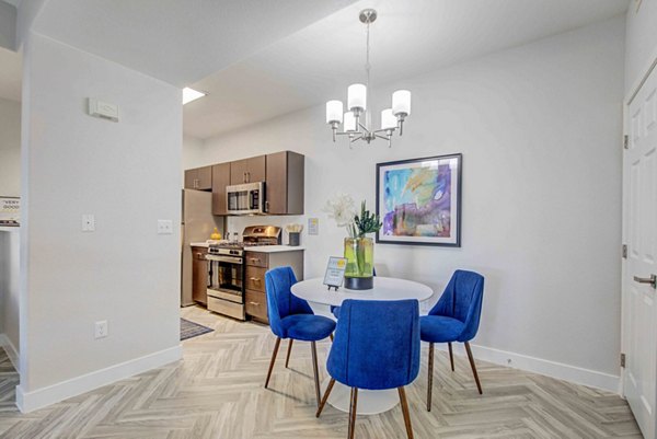 Modern dining area with sleek wooden table and pendant lighting at Citron Apartments in San Francisco
