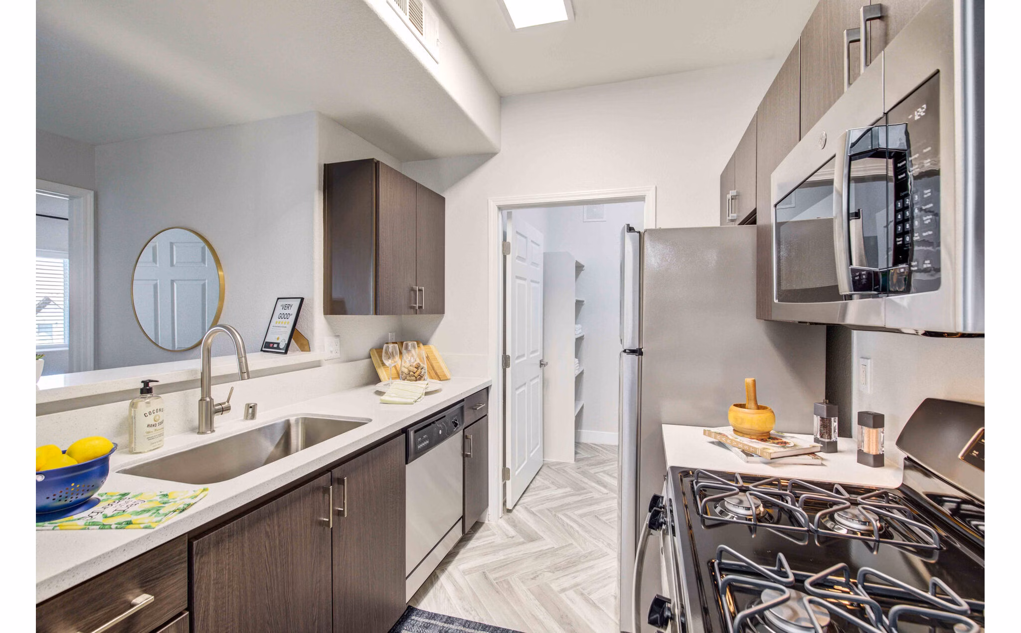 Modern kitchen with stainless steel appliances and granite countertops at Citron Apartments