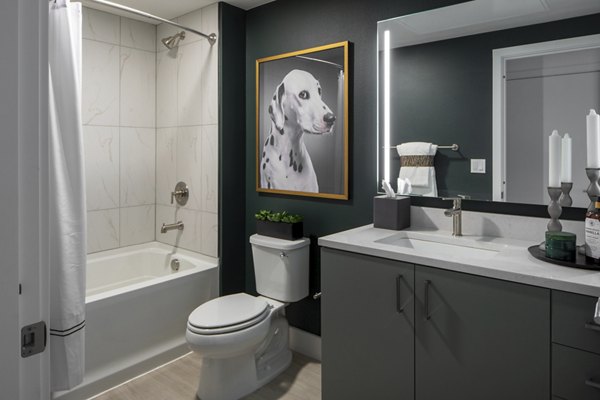 Bathroom featuring modern fixtures and dual vanities in Millhouse Apartments