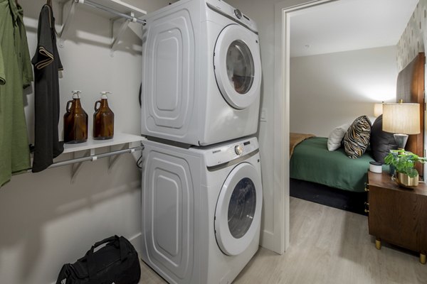 Laundry room with state-of-the-art washers and dryers at Millhouse Apartments