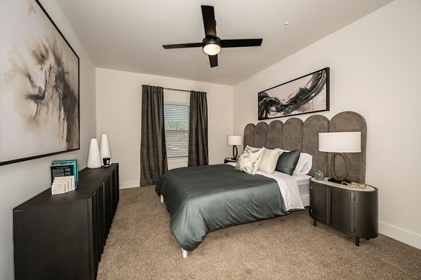 Cozy bedroom with modern decor at Perla Apartments