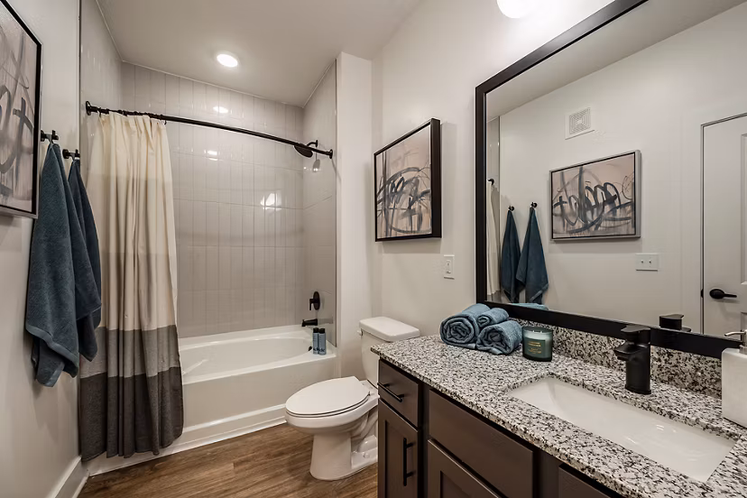 Luxurious bathroom featuring marble countertops and twin sinks at Perla Apartments