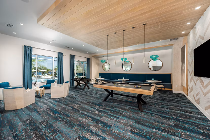 Clubhouse featuring modern design and cozy seating areas at Perla Apartments, luxury living in the heart of the city