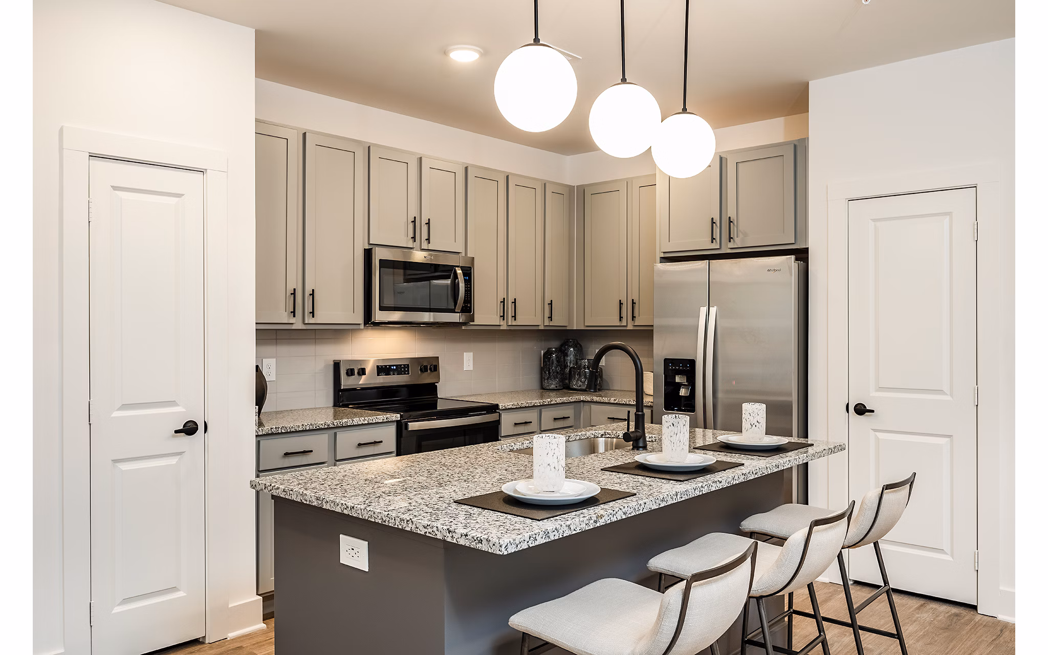 Modern kitchen featuring stainless steel appliances at Perla Apartments