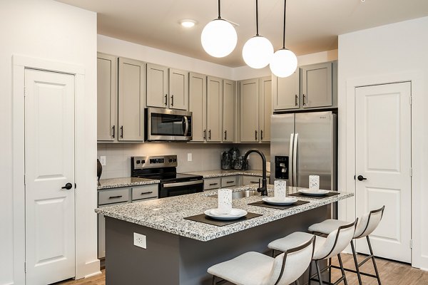 Modern kitchen featuring stainless steel appliances at Perla Apartments