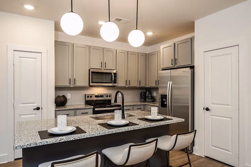 Modern kitchen with stainless steel appliances at Perla Apartments