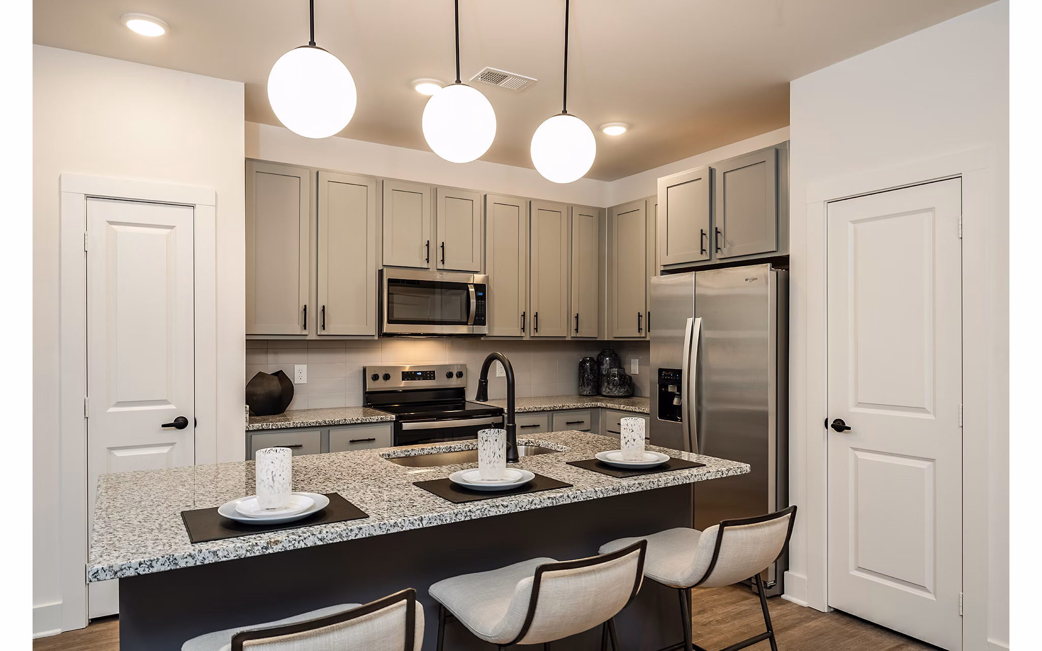 Modern kitchen with stainless steel appliances at Perla Apartments