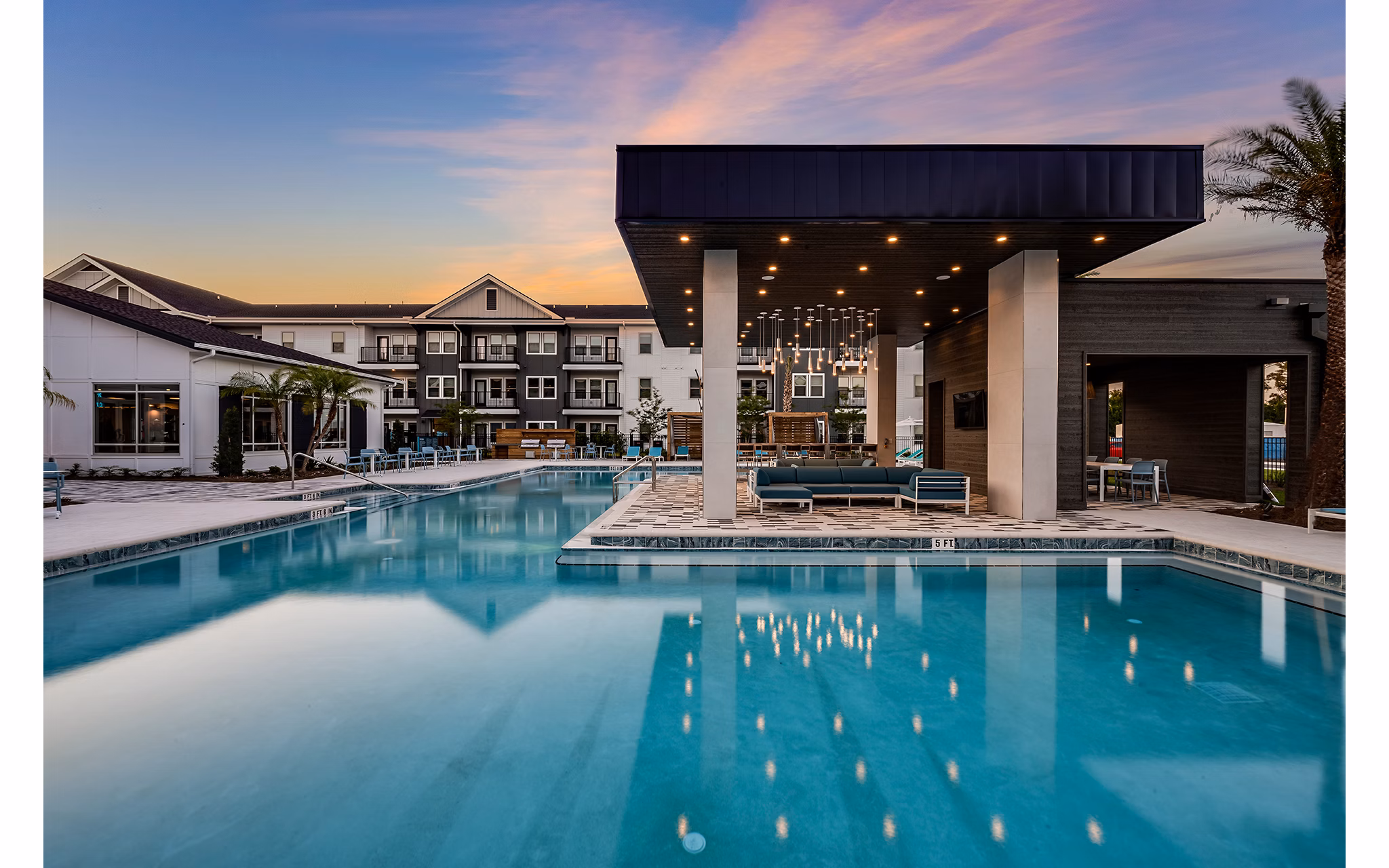 Luxurious outdoor pool with cabanas at Perla Apartments