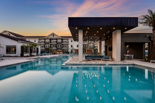 Luxurious outdoor pool with cabanas at Perla Apartments