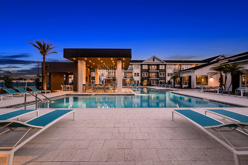 Rooftop pool with city skyline views at Perla Apartments