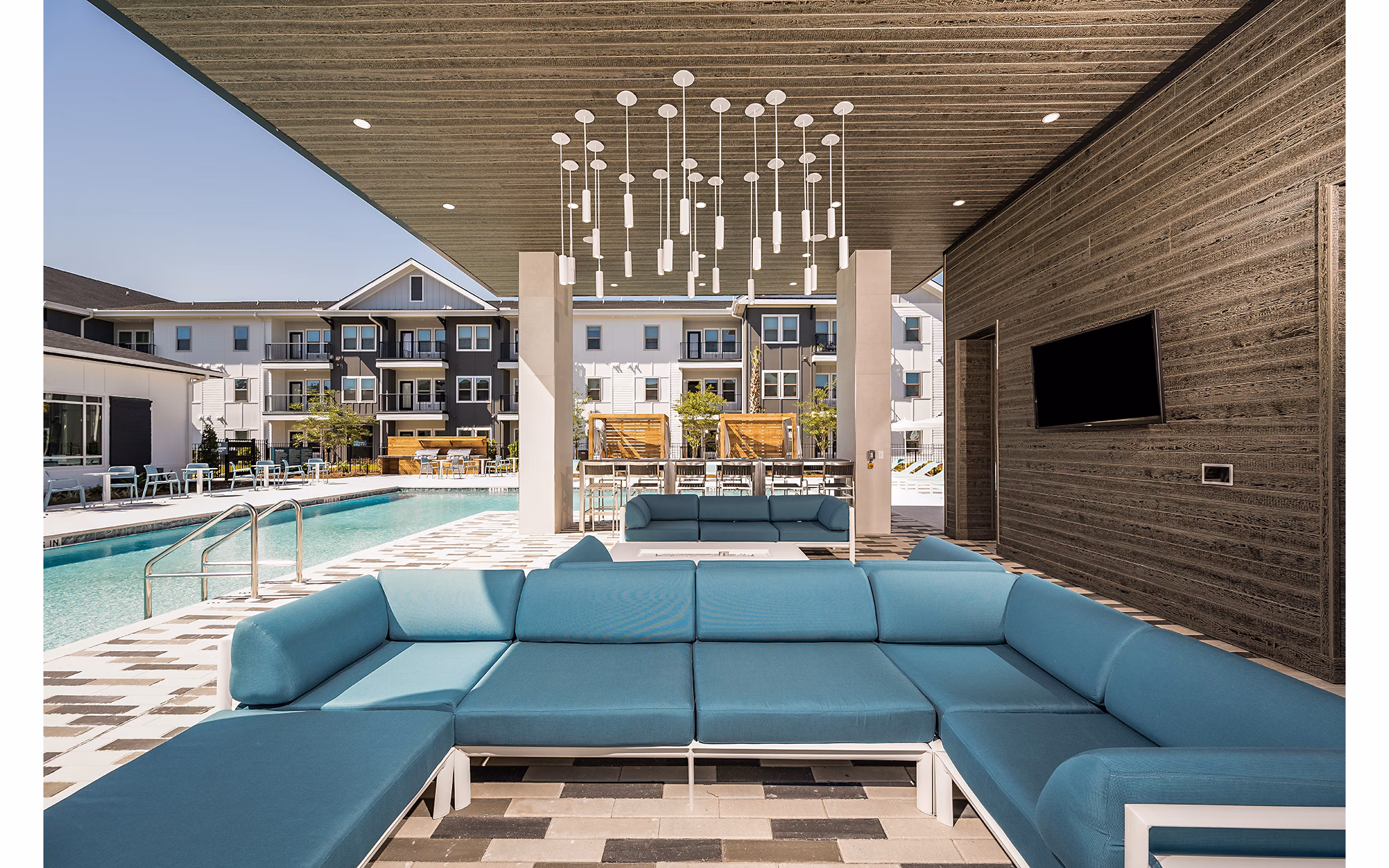 Chic patio adorned with lush greenery at Perla Apartments, perfect for relaxation in a luxury setting