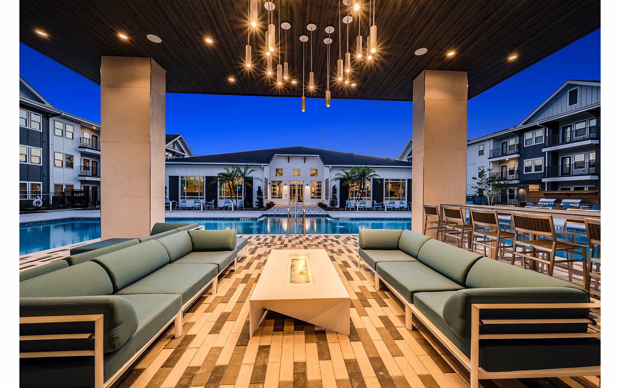 Cozy outdoor area with fire pit at Perla Apartments, offering a relaxing ambiance for residents and guests