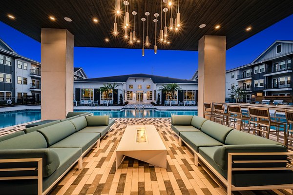 Cozy outdoor area with fire pit at Perla Apartments, offering a relaxing ambiance for residents and guests