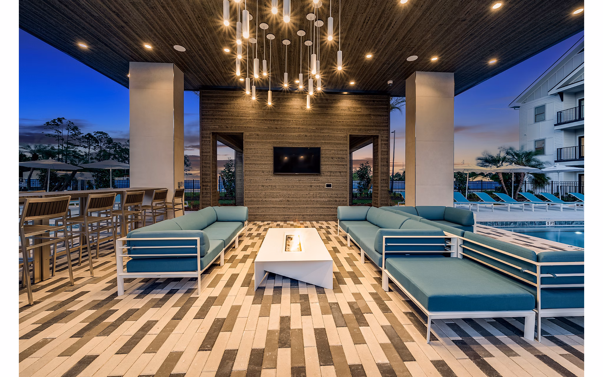 Outdoor fire pit lounge at Perla Apartments, a Greystar luxury community