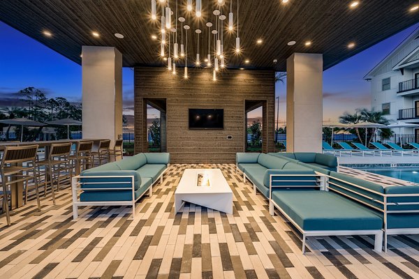 Outdoor fire pit lounge at Perla Apartments, a Greystar luxury community