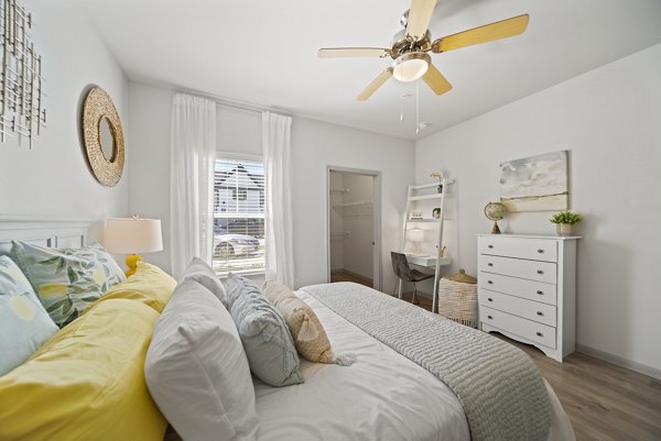 Cozy bedroom with stylish decor and natural light at Emerson at Trace Apartments