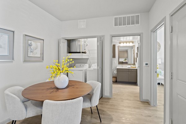 Dining area with modern decor and stylish lighting in Emerson at Trace Apartments