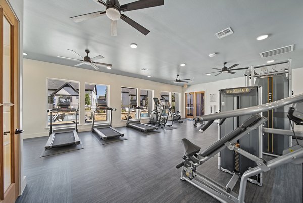 Emerson at Trace Apartments: Modern fitness center with state-of-the-art equipment and bright lighting