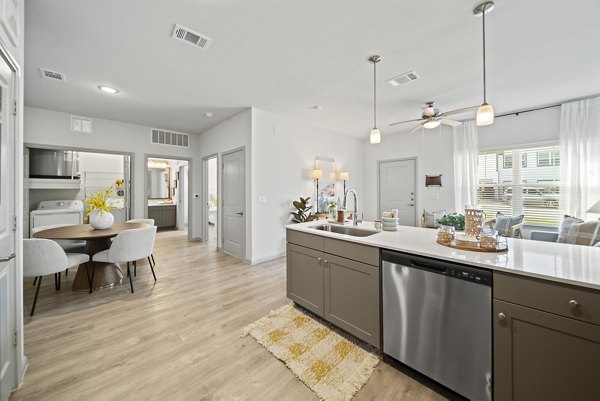 Contemporary kitchen with stainless steel appliances in Emerson at Trace Apartments