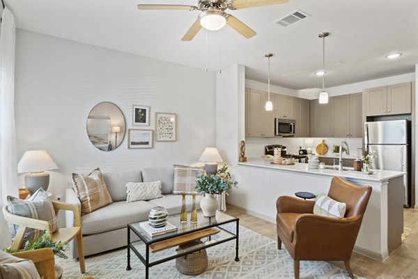 Living room with modern decor and ample natural light at Emerson at Trace Apartments