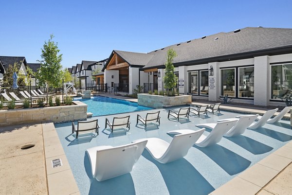 Poolside relaxation at Emerson at Trace Apartments with luxury lounging areas