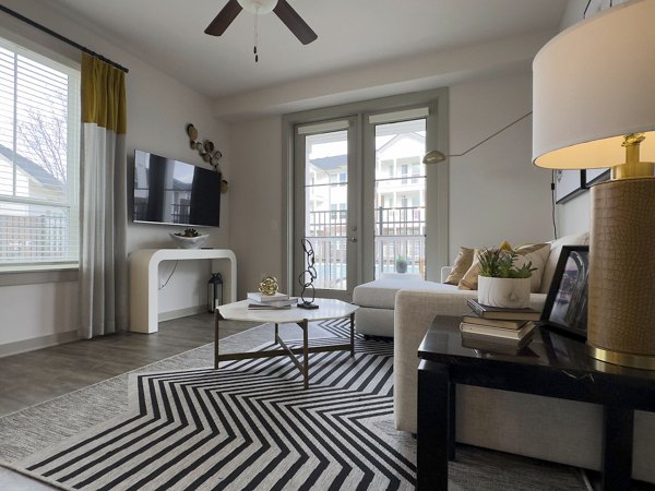 Elegant living room with large windows at The Fitzroy at Lebanon Marketplace Apartments, offering luxury interiors and modern design