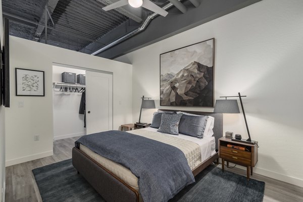 The Lofts at Westgate: Modern bedroom with stylish decor and natural light