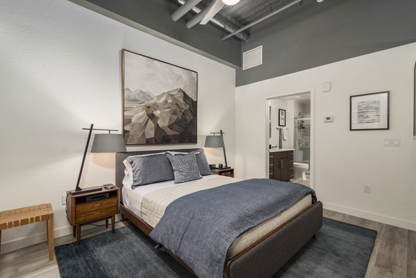 Cozy bedroom with modern decor at The Lofts at Westgate Apartments