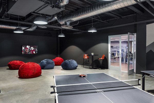 Game room with billiards and arcade machines at The Lofts at Westgate Apartments
