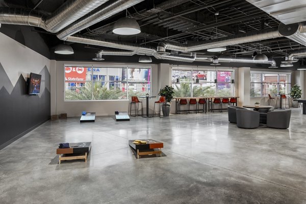 Vibrant game room with billiards and lounge seating at The Lofts at Westgate Apartments