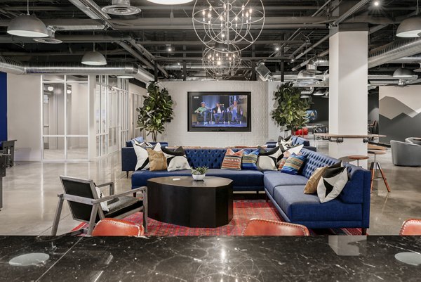 Clubhouse with modern furnishings at The Lofts at Westgate Apartments, offering luxury spaces for residents to relax and socialize