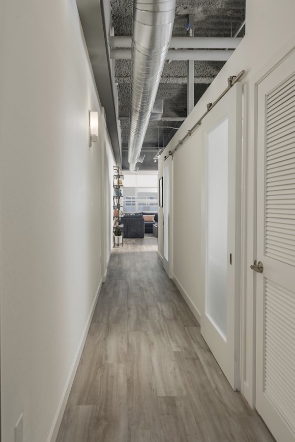 Modern hallway with stylish lighting at The Lofts at Westgate Apartments