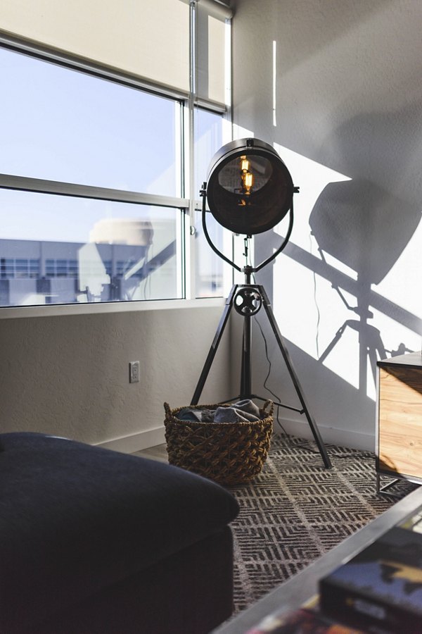 Stylish living room with modern decor and large windows at The Lofts at Westgate Apartments