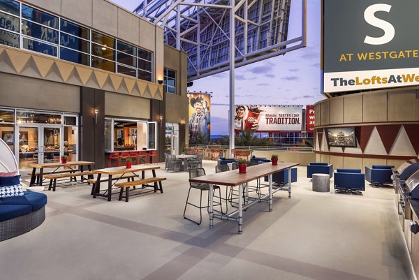 Rooftop deck with modern seating and city skyline views at The Lofts at Westgate Apartments