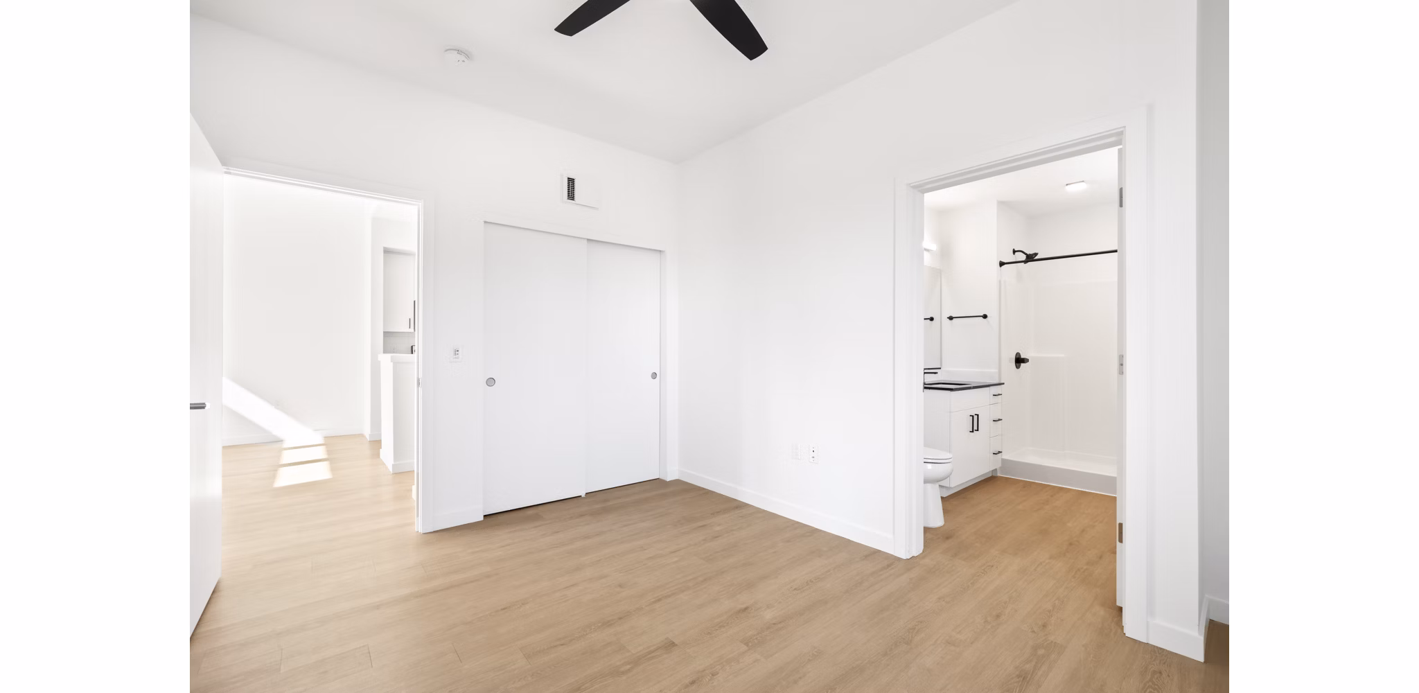 Elegant bedroom with modern furniture at Hudson West Apartments, a luxurious Greystar property in an upscale neighborhood