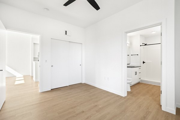 Elegant bedroom with modern furniture at Hudson West Apartments, a luxurious Greystar property in an upscale neighborhood