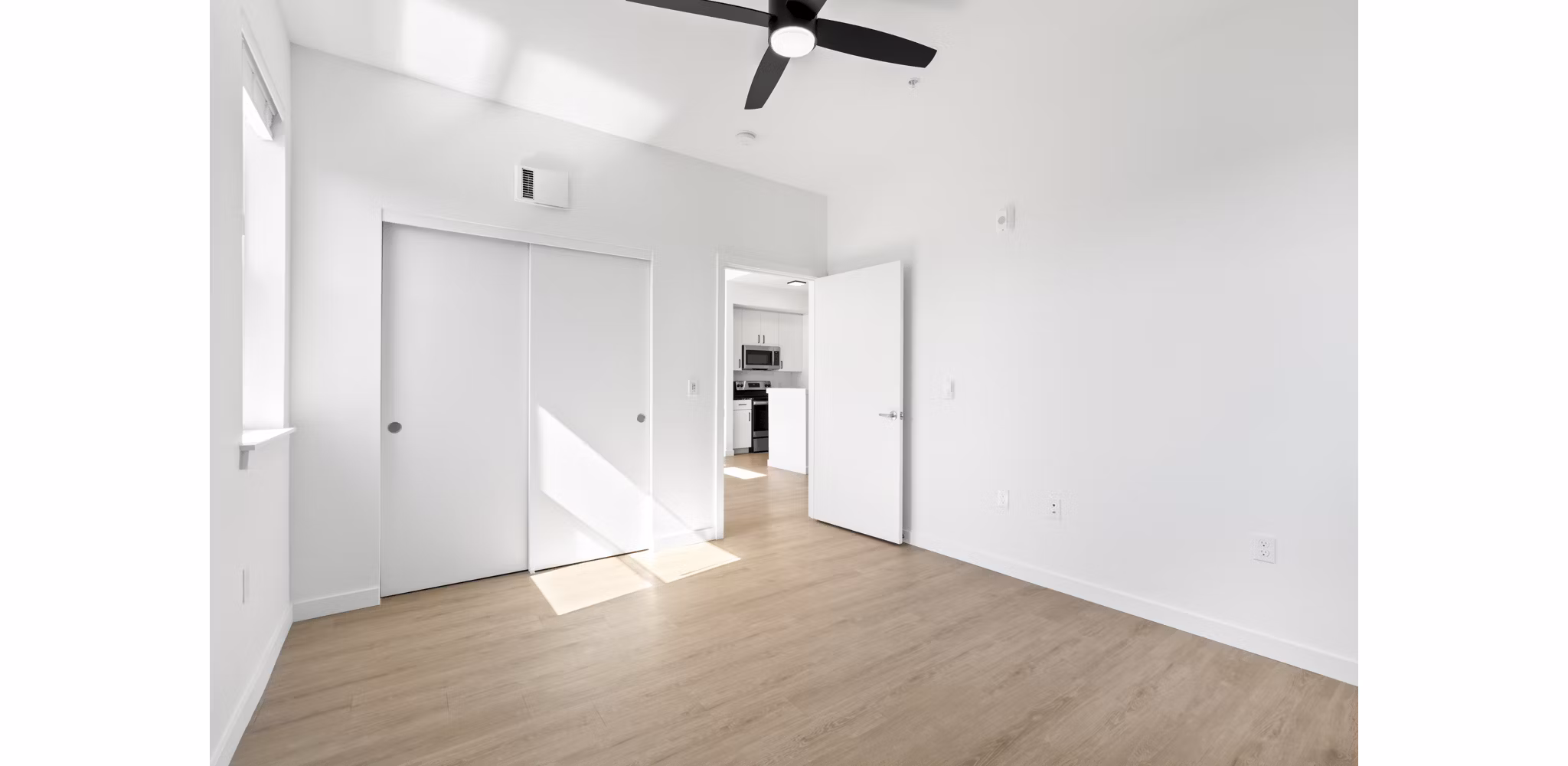 Cozy bedroom with natural lighting at Hudson West Apartments