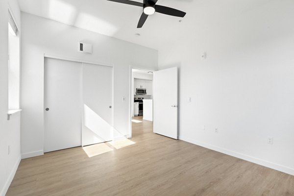 Cozy bedroom with natural lighting at Hudson West Apartments