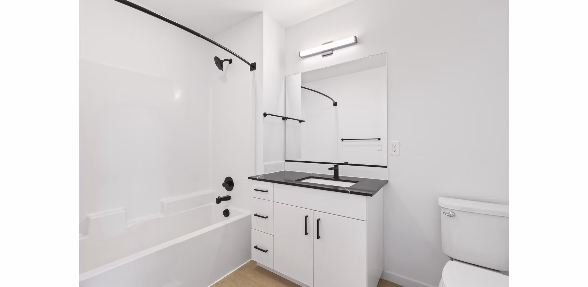 Modern bathroom with marble countertops and sleek fixtures at Hudson West Apartments