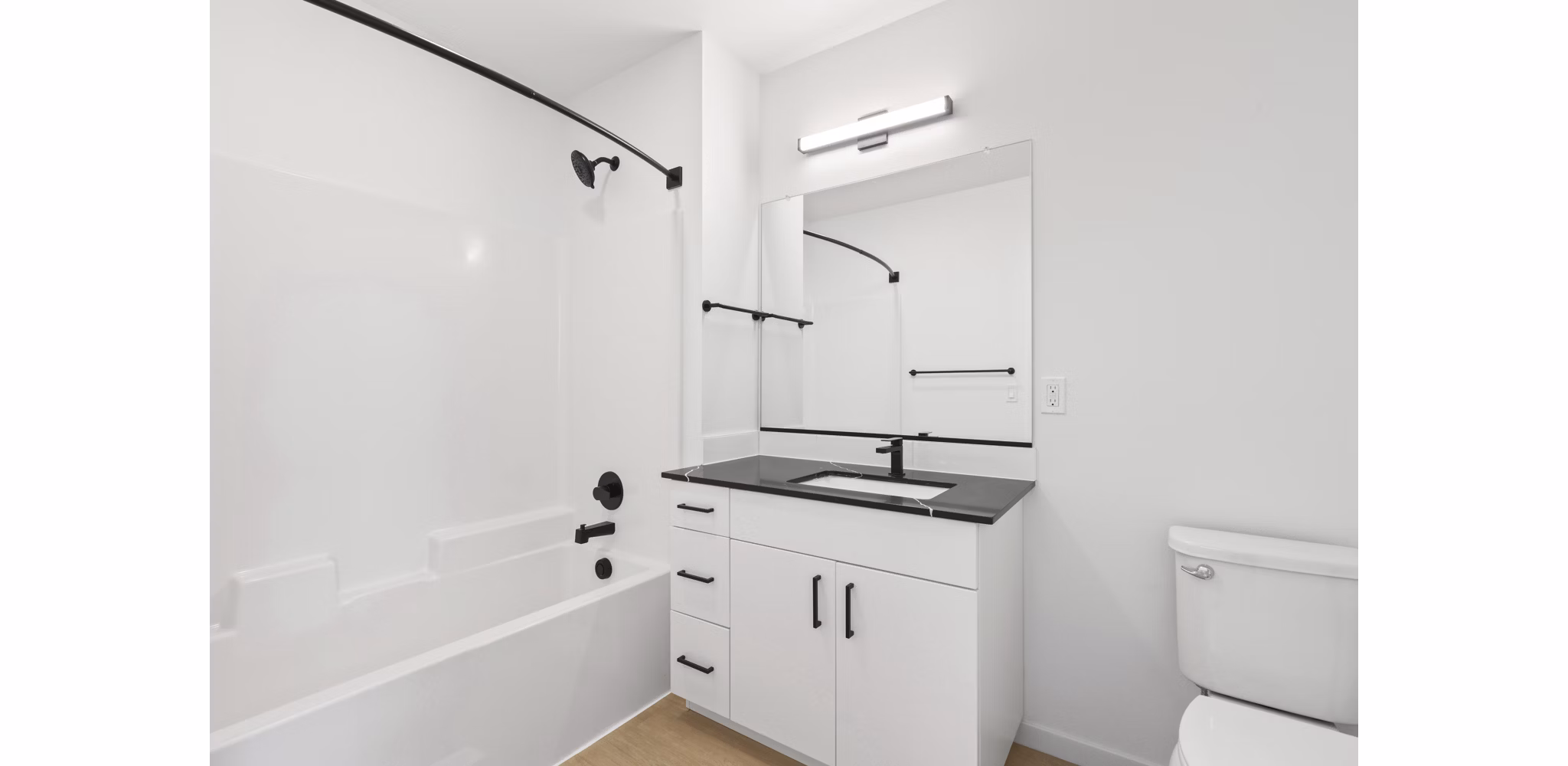 Modern bathroom with marble countertops and sleek fixtures at Hudson West Apartments