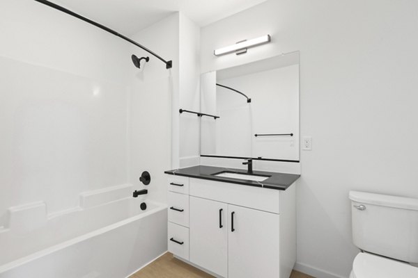 Modern bathroom with marble countertops and sleek fixtures at Hudson West Apartments