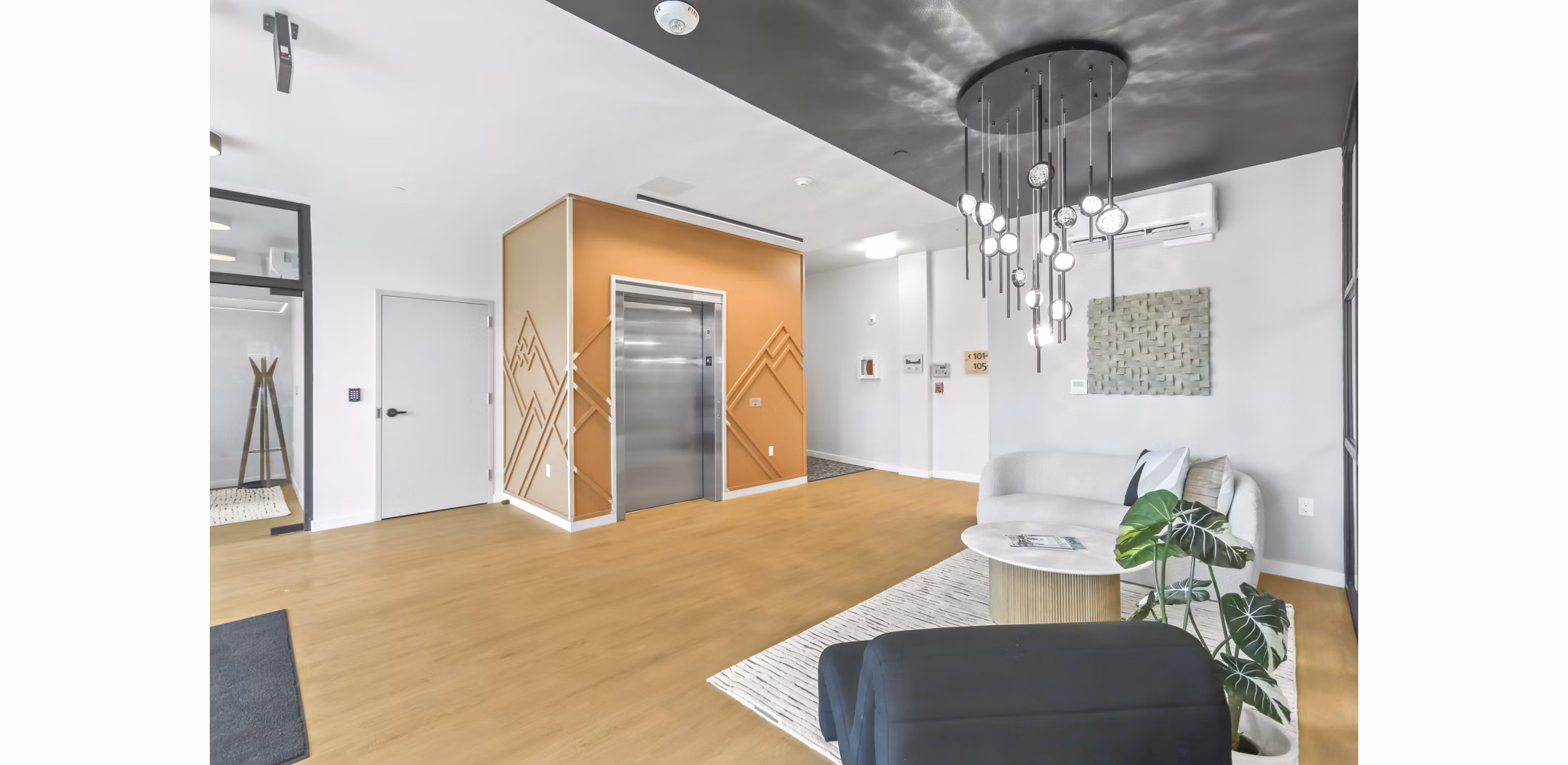 Inviting clubhouse with modern seating and a fireplace at Hudson West Apartments offering luxury and comfort for residents