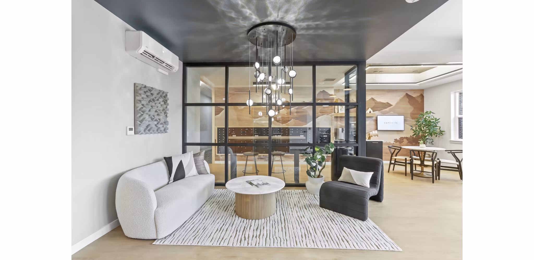Luxurious clubhouse with modern design at Hudson West Apartments, perfect for social gatherings and relaxation in a vibrant community setting