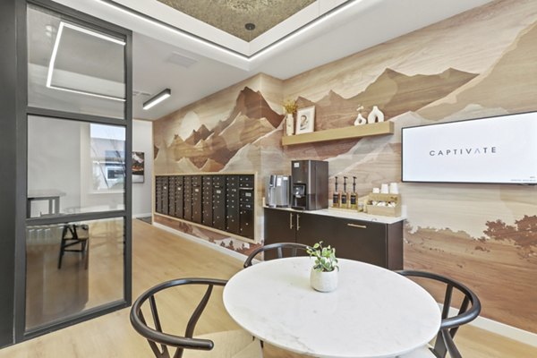 Modern clubhouse with stylish seating and billiards table at Hudson West Apartments, perfect for social gatherings and relaxation
