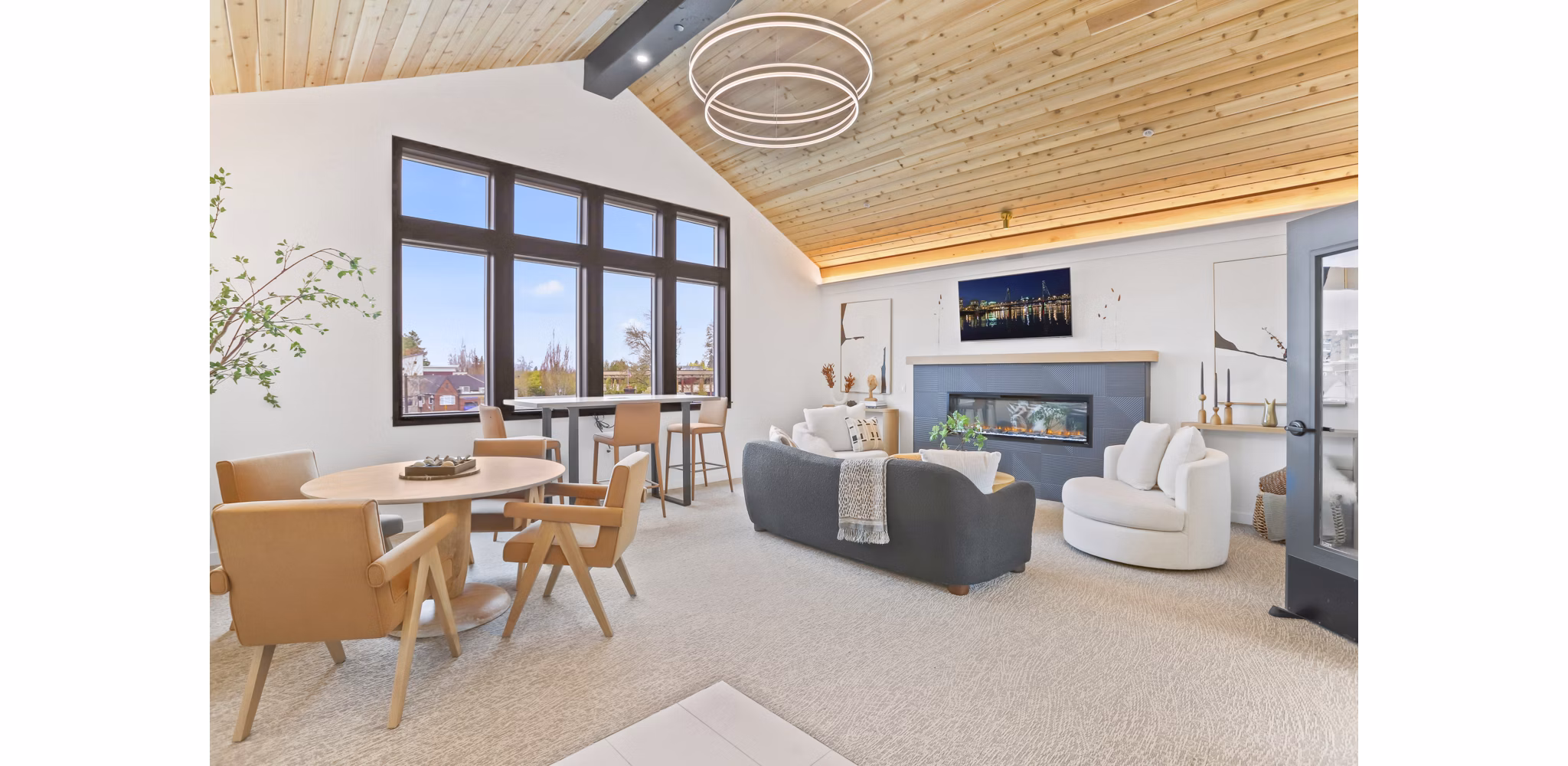 Clubhouse featuring modern decor and communal seating at Hudson West Apartments