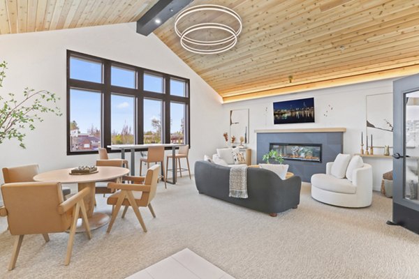 Clubhouse featuring modern decor and communal seating at Hudson West Apartments
