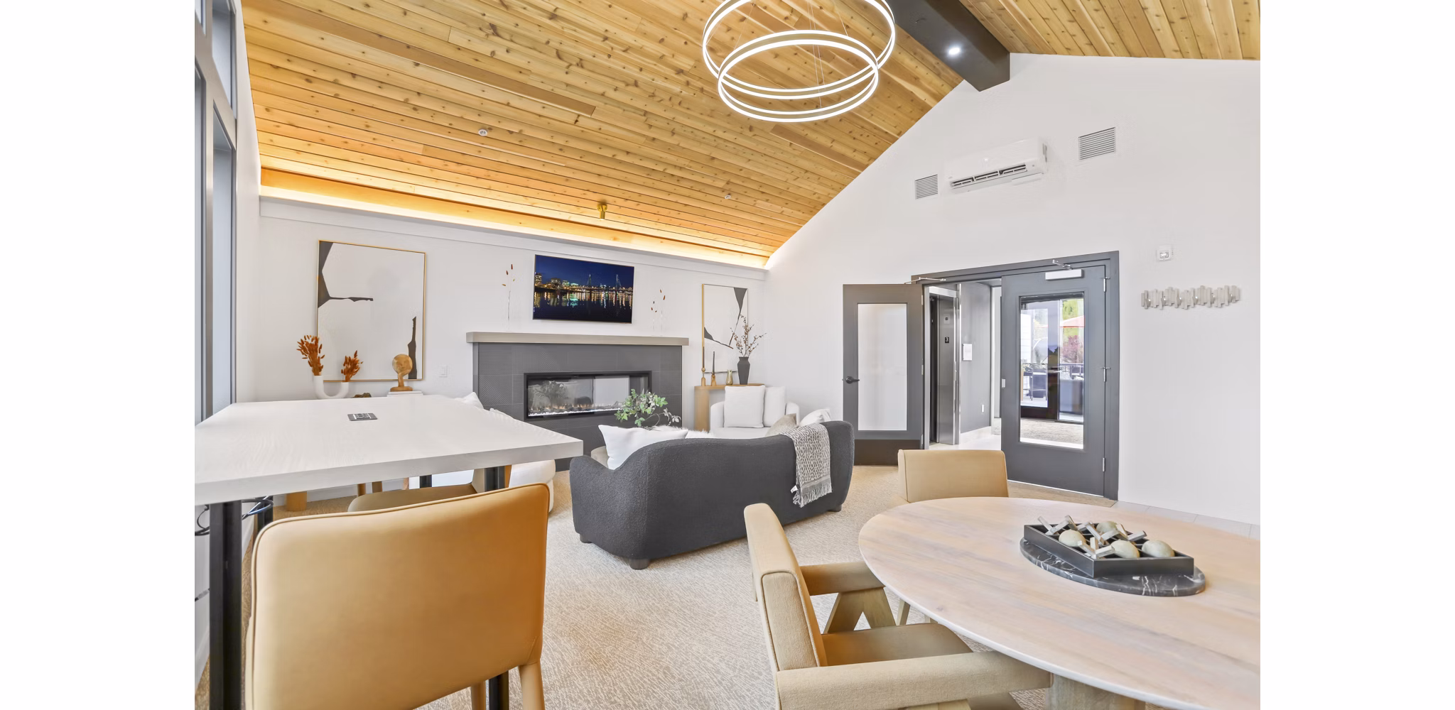 Clubhouse with modern decor and seating areas at Hudson West Apartments featuring luxury amenities for residents