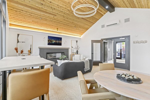 Clubhouse with modern decor and seating areas at Hudson West Apartments featuring luxury amenities for residents